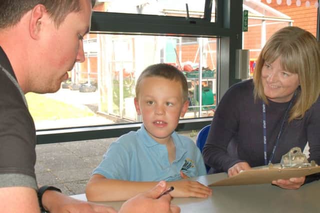 Birch Wood Special School teaching assistant Rob Peet and lead autism specialist Amy Dunstan with pupil Ashton Hallam EMN-161209-170310001