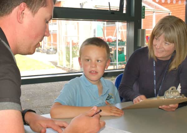 Birch Wood Special School teaching assistant Rob Peet and lead autism specialist Amy Dunstan with pupil Ashton Hallam EMN-161209-170310001