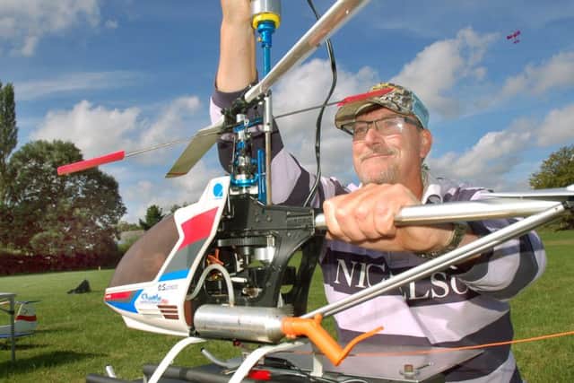 Melton Model Club member Bill Veitch makes adjustments to his Hirobo Shuttle Plus helicopter PHOTO: Tim Williams