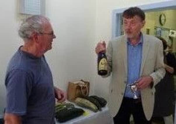 Paul Schober (right) receives his prize for the heaviest marrow from village hall trustee Michael Hunter PHOTO: Supplied