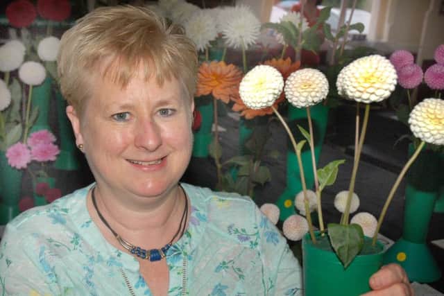 Judy Measures shows off her prize winning pom pom dahlias PHOTO: Tim Williams
