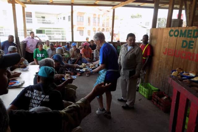 Melton Vineyard Church team member Ernie Braithwaite serving food at the feeding station EMN-160919-162526001