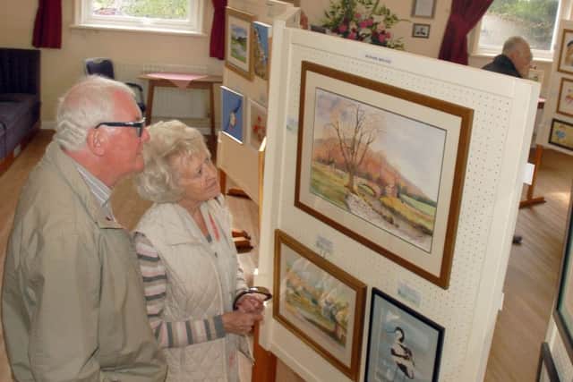 Local artist Maggie Pope and husband Ernie admire the artwork on display PHOTO: Tim Williams