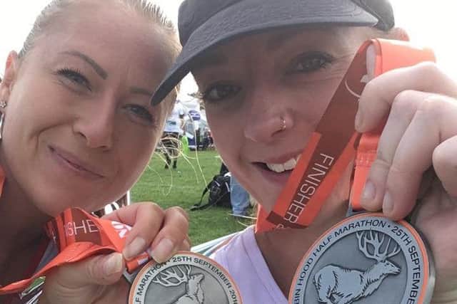 Melton friends Dani Woodward (right) and Amy Parr with their medals after finishing the Robin Hood Half Marathon EMN-160925-162826001