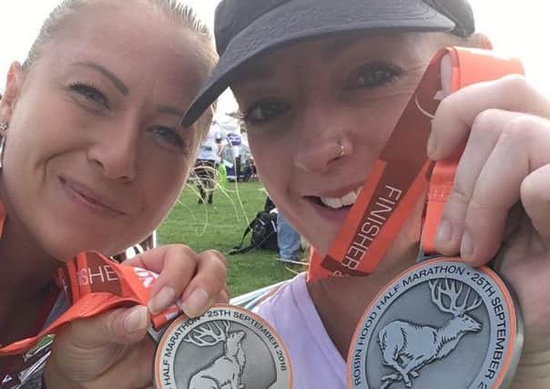 Melton friends Dani Woodward (right) and Amy Parr with their medals after finishing the Robin Hood Half Marathon EMN-160925-162826001
