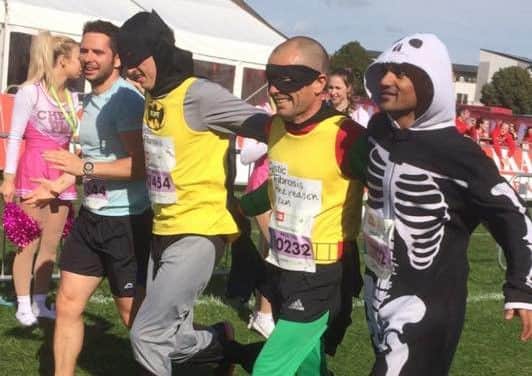 John Ferneley College sports ambassador Paul Jacobs and former student Joe Pope (centre), dressed as Batman and Robin, with two fellow runners they completed the Robin Hood Marathon with EMN-160925-163348001