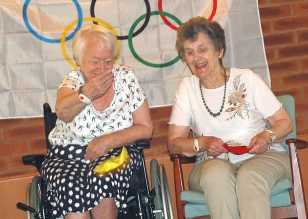 Gretton Court residents Marie Carter and Audrey Waite enjoy their bean-bag throwing challenge PHOTO: Tim Williams
