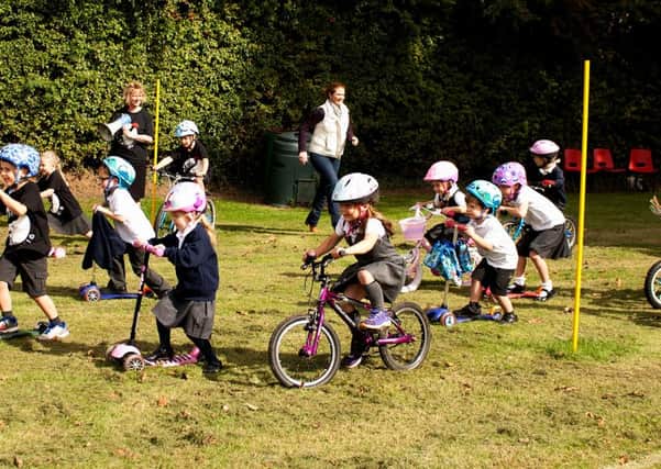 Energetic pupils put in a wheely good effort around the school field PHOTO: Supplied