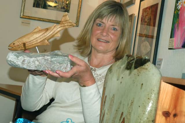 Organiser Anne Copley with one of Ken Chapman's wood carvings PHOTO: Tim Williams EMN-151110-110109001