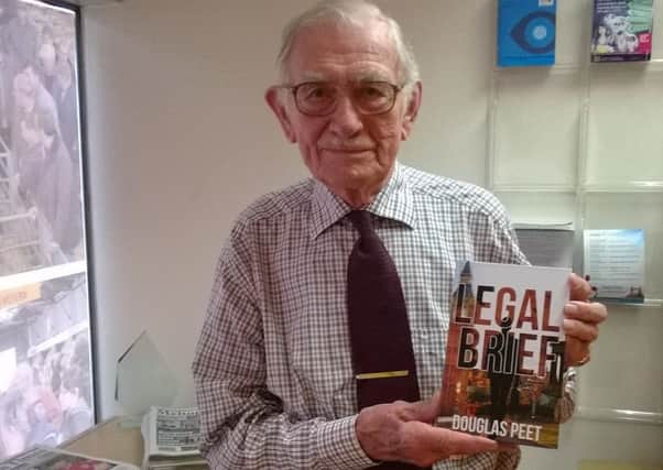 Melton man Douglas Peet (91) with a copy of his first book 'Legal Brief' EMN-160930-170301001