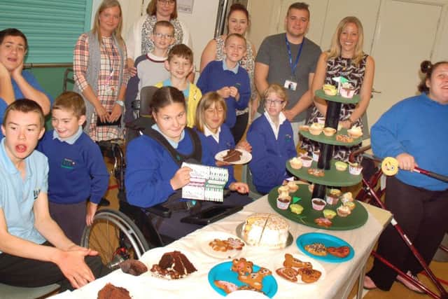 Key stage four pupils at Birch Wood School held a coffee morning and washed cars which raised Â£260 for Macmillan. Laura Graham also shaved her head on the day and raised Â£1,600, which is enough to fund a Macmillan nurse for a week PHOTO: Tim Williams