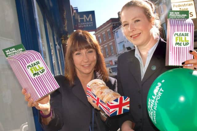 Nottingham Building Society staff Samantha Clark and Sophie Brooks on cake duty. They raised Â£220 PHOTO: Tim Williams