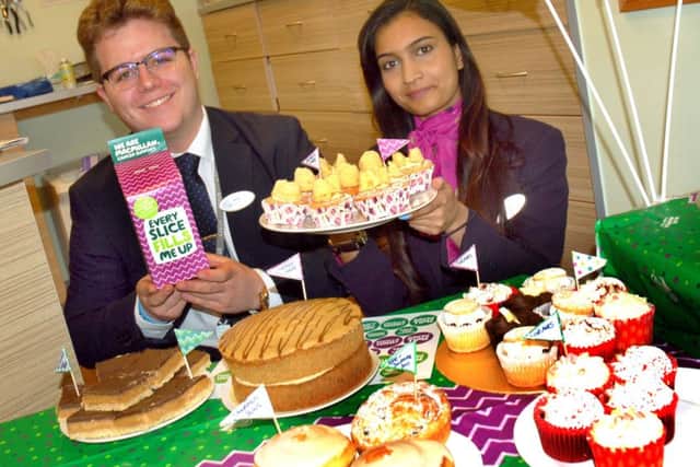 Aidan Leckie and Ashreeta Anbaran with Specsavers' tempting spread. They raised Â£124 PHOTO: Tim Williams