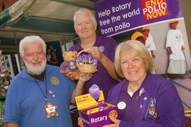 Paul Saxby with John and Susan Herlihy on the stall of the various Rotary groups in the Melton area PHOTO: Tim Williams