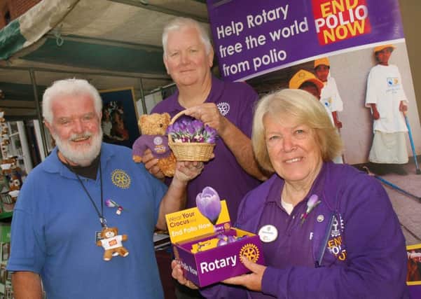 Paul Saxby with John and Susan Herlihy on the stall of the various Rotary groups in the Melton area PHOTO: Tim Williams