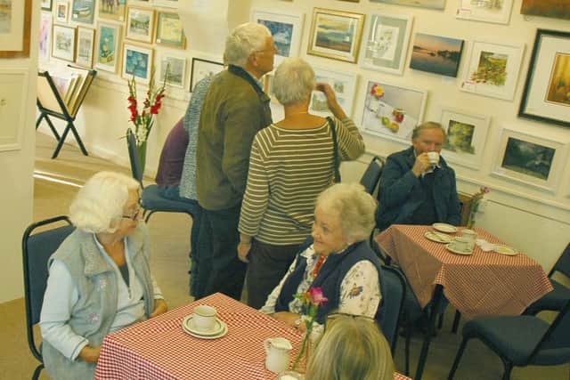 Visitors enjoy the art work and a cuppa at the show PHOTO: Tim Williams