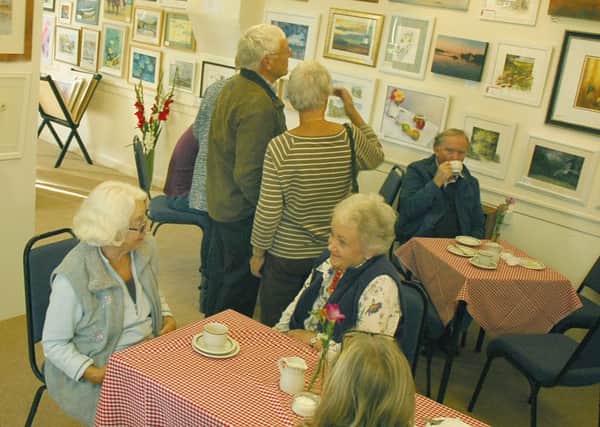 Visitors enjoy the art work and a cuppa at the show PHOTO: Tim Williams
