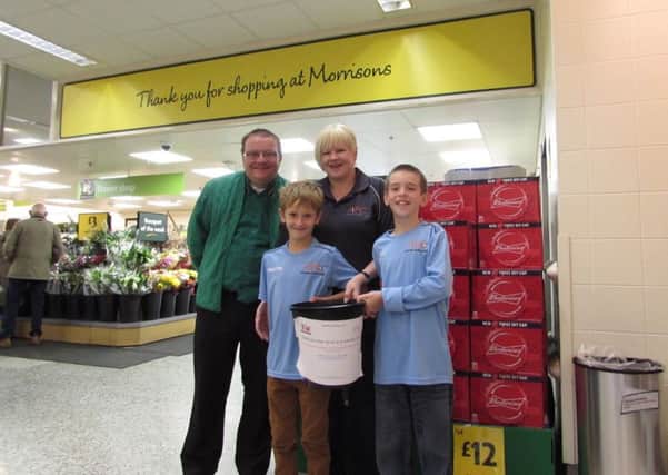 Sarah Wilson, Rob Morrish and some of the Asfordby Amateurs players who helped bag pack at Morrisons PHOTO: Supplied