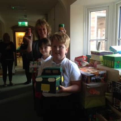 Waltham School pupils and their headteacher Julie Hopkins deliver harvest boxes to Dove Cottage Day Hospice in Stathern, following their church service PHOTO: Supplied