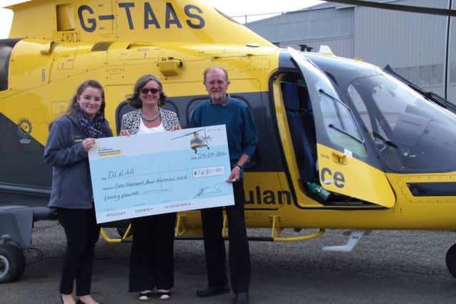 The Crown Inn landlords Anna and Alan Edmunds present a cheque for £1,430 to a charity representative of the Derbyshire, Leicestershire
and Rutland Air Ambulance PHOTO: Supplied