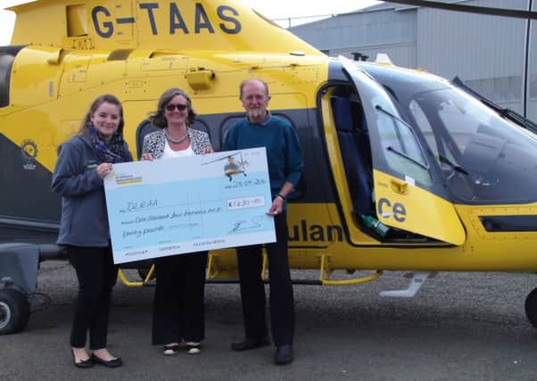 The Crown Inn landlords Anna and Alan Edmunds present a cheque for Â£1,430 to a charity representative of the Derbyshire, Leicestershire
and Rutland Air Ambulance PHOTO: Supplied