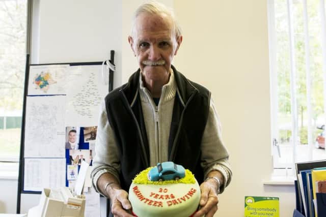 Roger Hodson with a celebratory cake to mark his 20-year service as a driver with Voluntary Action Melton EMN-161031-120811001