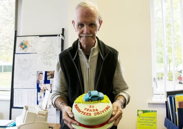 Roger Hodson with a celebratory cake to mark his 20-year service as a driver with Voluntary Action Melton EMN-161031-120811001
