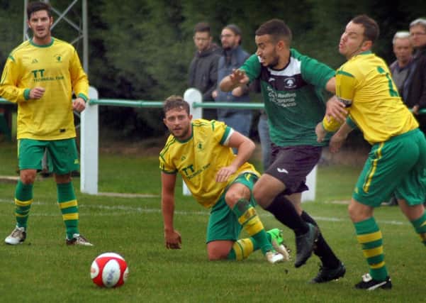 Holwell skipper Aaron Ridout tangles with a Greenwood player as Chris Hibbitt and Kieran Foster look on during Saturday's home defeat EMN-160211-092551002