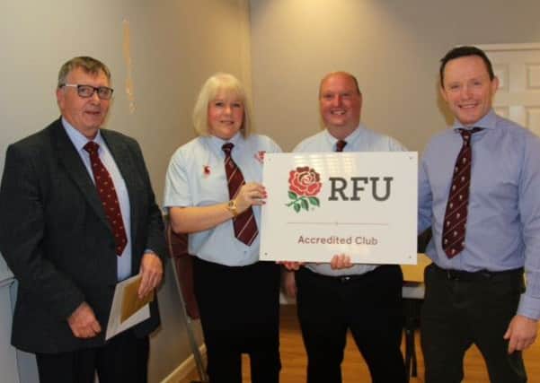 Leicestershire Rugby Union president Brian Hesford (left) presents the RFU award to Melton RFC minis and junior chairman Debra Gilbert, Andrew Thorpe and senior club chairman Marcus Twidale EMN-160211-111756002