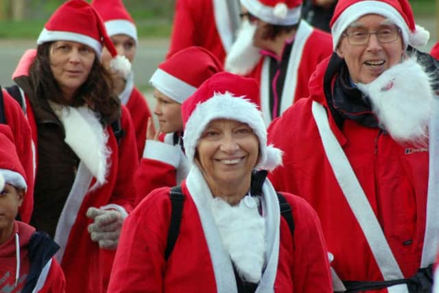 Smiling Santas enjoy a pre-run warm up PHOTO: Tim Williams