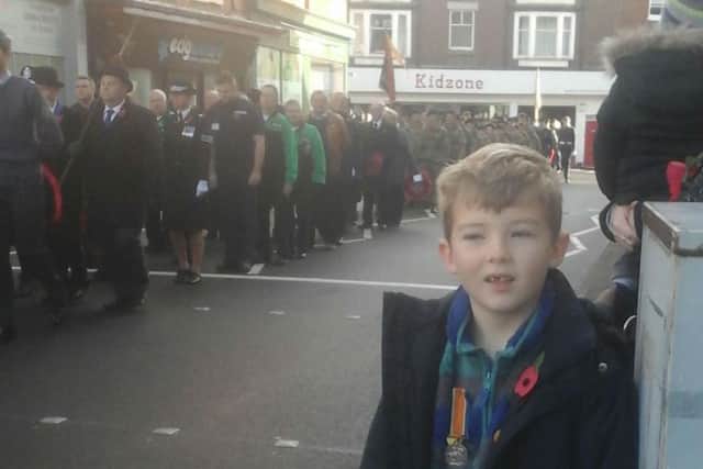 Danny Parker-Allen (7) proudly wears one of his great-great-grandfather's First World War medals during Sunday's Remembrance parade through Melton EMN-161116-091112001