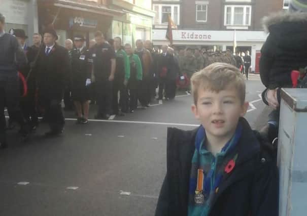 Danny Parker-Allen (7) proudly wears one of his great-great-grandfather's First World War medals during Sunday's Remembrance parade through Melton EMN-161116-091112001