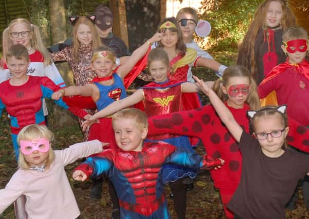 Pupils at Asfordby Hill School who helped raise more than ?1,700 for a new defibrillator for the village with a 'Super Heroes Day' EMN-161114-101632001
