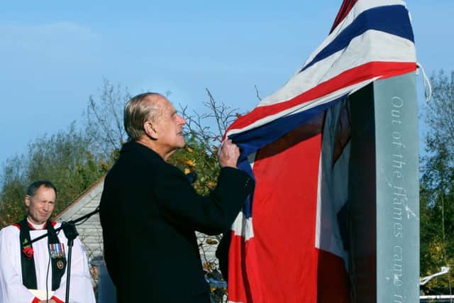 The Duke of Edinburgh helps Dr Sandy Saunders unveil a new memorial to the iconic Guinea Pig Club at the National Memorial Arboretum EMN-160911-111345001