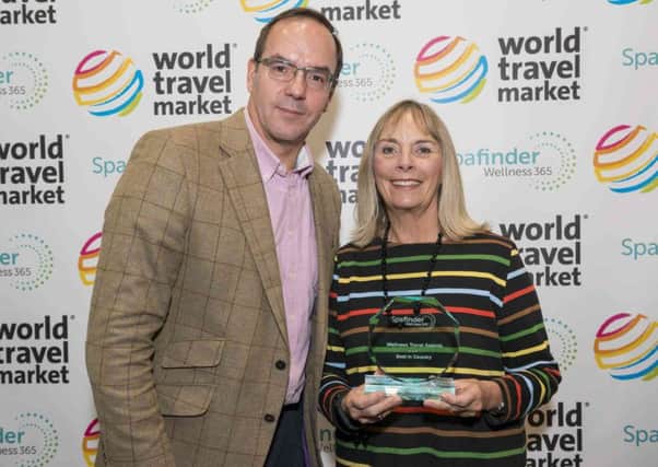 Spafinder Wellness chief operating officer John Bevan presents the award for UKs Best Spa to Ragdale Hall co-owner Penny Nesbitt EMN-161114-151413001