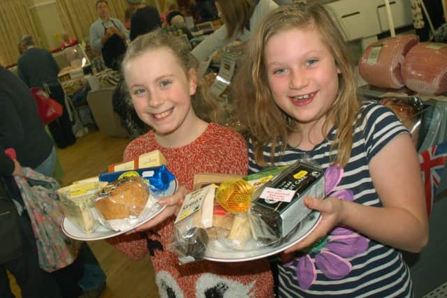 Emily Collins and Imogen Kingston found some local tasty treats from Melton Cheeseboard and the Fairtrading Post PHOTO: Tim Williams