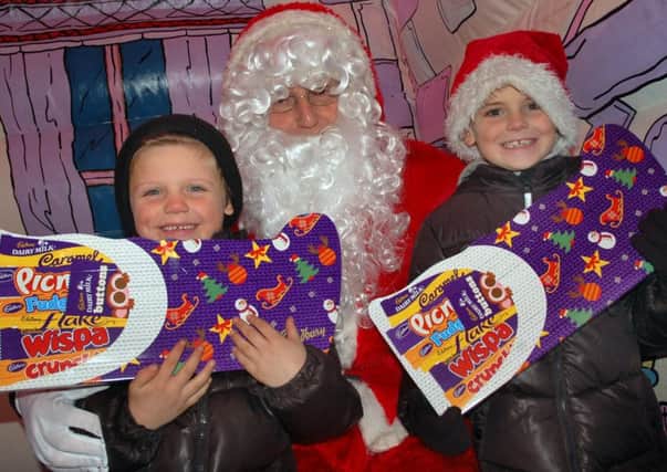 Five-year-old Jack Kennedy and brother Kye (7) meet Santa in his grotto PHOTO: Tim Williams