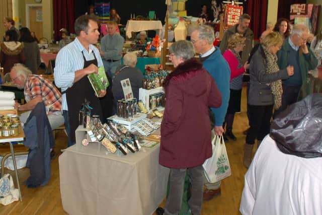 Food fans browse the products on the various stalls at the village hall PHOTO: Tim Williams
