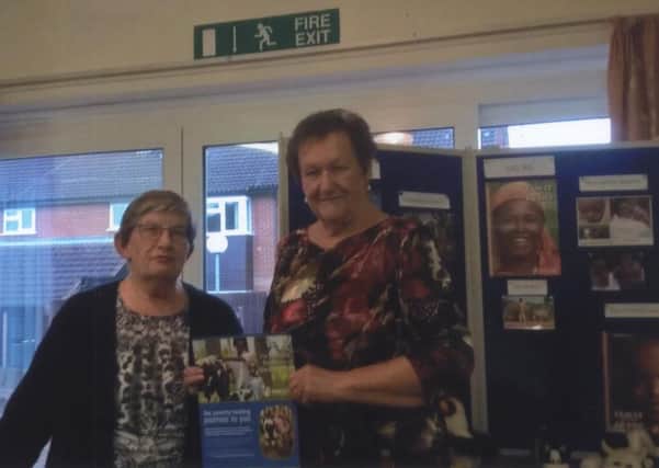 Janet Key presents a certificate to Linda Peters for the centre's wonderwall PHOTO: Supplied