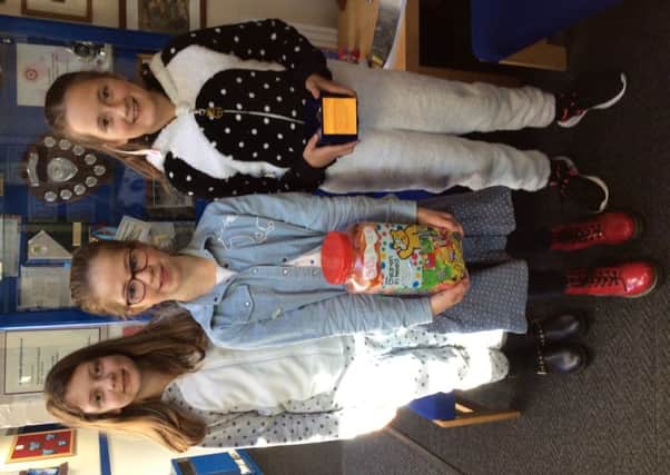 Children at Harby Primary School hosted a dress up in spots day and held a guess how many sweets are in the jar competition. The school raised Â£150.58 PHOTO: Supplied