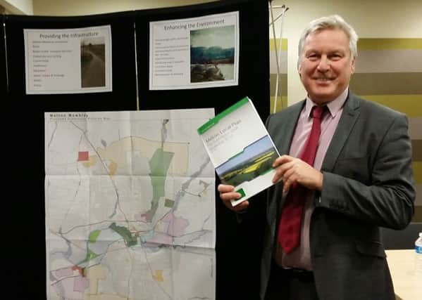 Jim Worley, Melton Council's head of regulatory services, hold a copy of Melton's draft Local Plan document at Tuesday evening's final public consultation event EMN-161130-132009001
