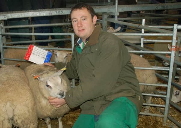 Robert West shows off his Champion Lambs at the Melton Fatstock Show EMN-161130-152404001