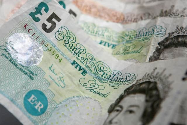 File photo dated 25/03/10 of five pound notes as ATM operator Bank Machine has launched a network of free cash machines that only dispense £5 notes. PRESS ASSOCIATION Photo. Issue date: Monday June 28, 2010. The group has installed 21 cash machines across Britain that only give out fivers, regardless of how much money is withdrawn. See PA story MONEY ATM. Photo credit should read: Gareth Fuller/PA Wire EMN-161128-115513001