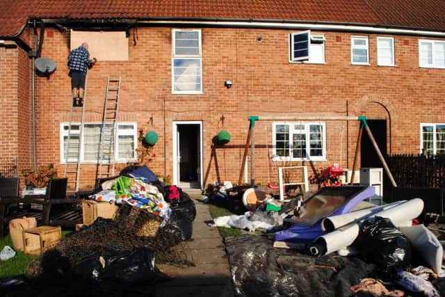 Ruined belongings fill the front garden following the fire at the house in Easthorpe Lane, Redmile.