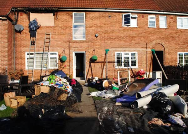 Ruined belongings fill the front garden following the fire at the house in Easthorpe Lane, Redmile.