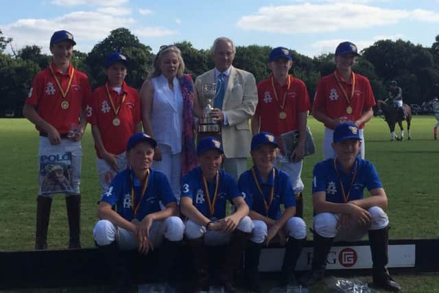 Marcus with the Young England squad who played for the Colts Cup at Ham Polo Club in August. Nicholas Coloquon-Denvers, chairman of the
Federation of International Polo (FIP), presents the trophy EMN-160212-113733002