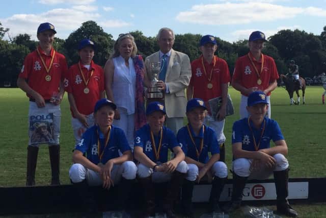 Marcus with the Young England squad who played for the Colts Cup at Ham Polo Club in August. Nicholas Coloquon-Denvers, chairman of the 
Federation of International Polo (FIP), presents the trophy EMN-160212-113733002
