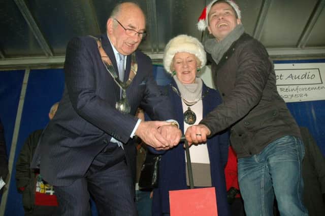 Mayor David Wright and wife Maureen assist Stuart Earp on plunger duties PHOTO: Tim Williams