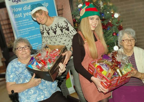 MV16 elves Reece Bishop and Shannon Riley deliver their hampers to Christine Clayton and Francina Christmas PHOTO: Tim Williams