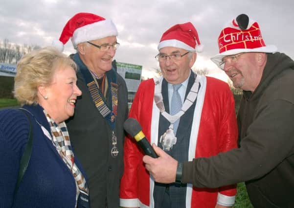 Mayoress Maureen Wright has a festive chat with 103's Big E while Rotary president Ian Neale and Mayor David Wright wait their turn PHOTO: Tim Williams